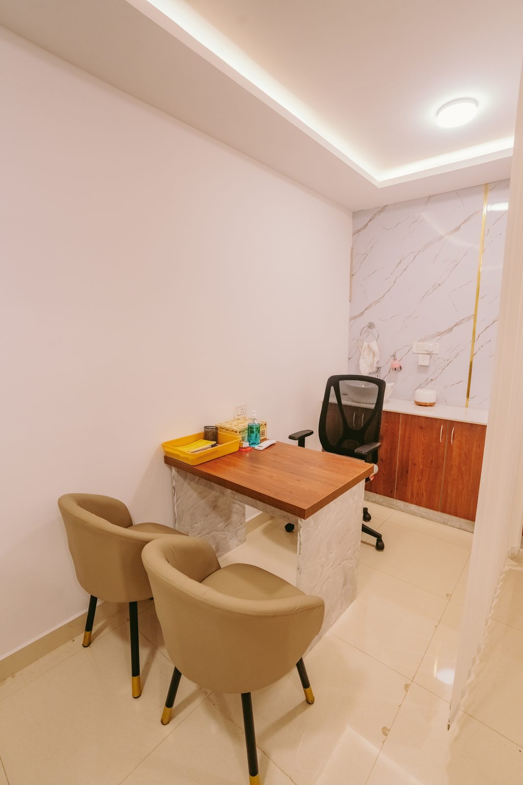 Consultation room with patient chairs and desk