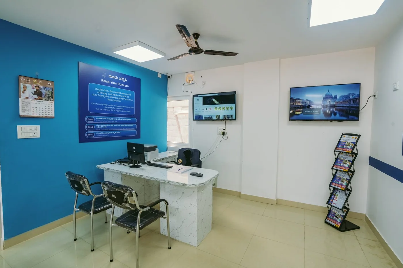 Karmika Seva Kendra citizen help desk with welfare scheme information boards