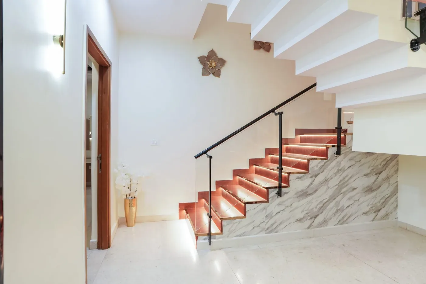 Marble staircase with softly lit treads in a completed residence