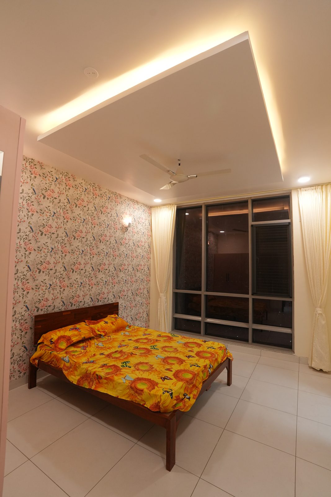 Bedroom with wallpaper feature wall and balcony access
