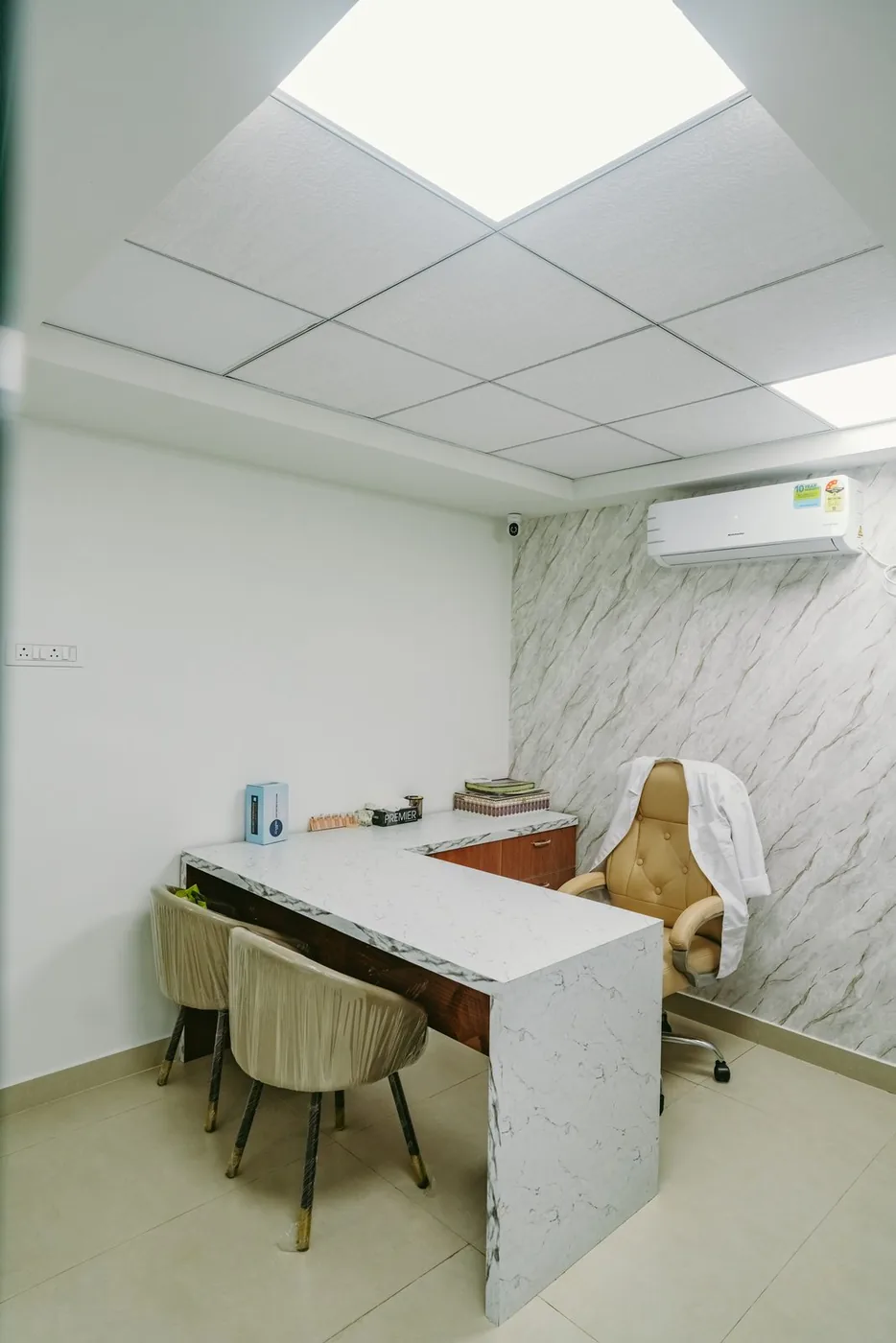 Apollo Akshaya Nagar Consulting Cabin — A compact cabin built around a stone-topped desk.